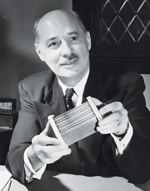 FIG. 2. Eugene Houdry holding a small catalytic converter. Photo courtesy of Sunoco and the Science History Institute.