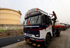 A man climbs an an oil tanker parked outside a fuel depot in Mumbai, October 6, 2017. REUTERS/ Danish Siddiqui/Files