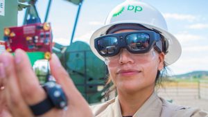 A BPX technician reads sensor information on her smart glasses out in the field that is relayed to an expert in the control center (Photo Source: BP)