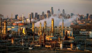 The Philadelphia Energy Solutions oil refinery is seen at sunset in front of the Philadelphia skyline in Pennysylvania, U.S., March 24, 2014. REUTERS/David M. Parrott/File Photo